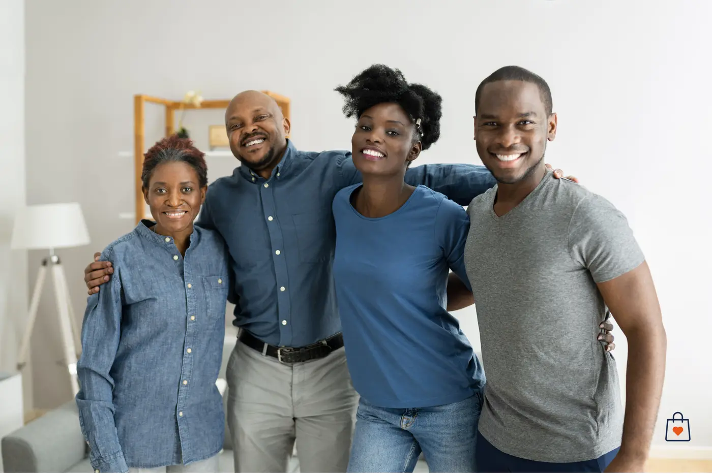 Four smiling friends standing together in a living room